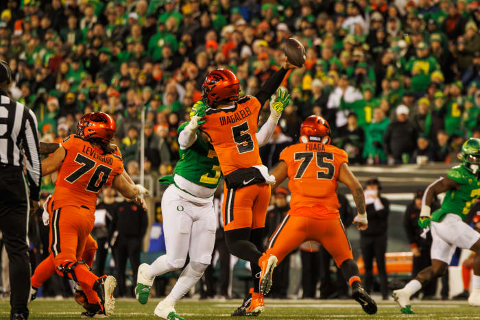 Oregon Ducks defensive lineman Brandon Dorlus rushes Oregon State quarterback DJ Uiagalelei.